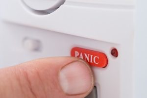 Close-up Of Person's Hand Pressing Panic Button